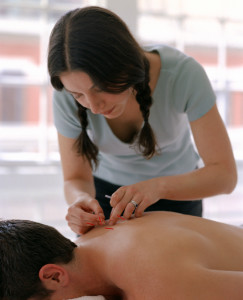 Acupuncturist with patient
